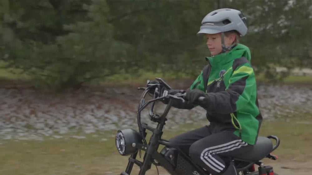 A kid wearing a helmet and green jacket riding a black EILLEO M6 fat tire electric bike on a dirt trail, followed by close-up product showcase of the headlight, rear suspension, and frame.